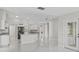 Bright kitchen with stainless steel appliances, granite countertops, and white cabinets at 11743 Se 174Th Loop, Summerfield, FL 34491