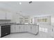Modern kitchen with granite counters, white cabinets, and stainless steel appliances at 11743 Se 174Th Loop, Summerfield, FL 34491