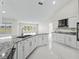 Modern kitchen with granite counters, white cabinets, and stainless steel appliances at 11743 Se 174Th Loop, Summerfield, FL 34491