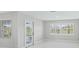Bright living room features tile flooring, access to the pool, and plantation shutters at 11743 Se 174Th Loop, Summerfield, FL 34491