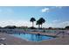 Relaxing community pool area with lounge chairs and a calming atmosphere for residents to enjoy at 11743 Se 174Th Loop, Summerfield, FL 34491