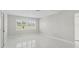 Bright room with neutral walls, sleek tile flooring, and plantation shutters on the windows at 11743 Se 174Th Loop, Summerfield, FL 34491