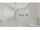 Bright room with neutral walls, sleek tile flooring, and plantation shutters on the windows at 11743 Se 174Th Loop, Summerfield, FL 34491