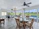 Bright sunroom features tile flooring, ceiling fans, and a view of the pool and golf course at 11743 Se 174Th Loop, Summerfield, FL 34491