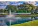 Community entrance sign, Stonecrest, beside a pond with a decorative water fountain at 11743 Se 174Th Loop, Summerfield, FL 34491