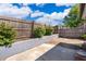 View of the fenced back yard with raised garden bed and small patio area at 1306 Vine St, Leesburg, FL 34748