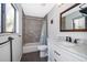 Modern bathroom featuring a vanity with marble countertop and sleek fixtures at 1306 Vine St, Leesburg, FL 34748