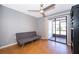 Bedroom with ceiling fan, wood floors, and sliding glass door to the patio at 1306 Vine St, Leesburg, FL 34748