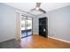 Bedroom with ceiling fan, wood floors, and sliding glass door to the patio at 1306 Vine St, Leesburg, FL 34748