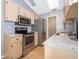 Well-lit kitchen with stainless steel appliances, granite countertops, and neutral cabinets offering a clean aesthetic at 1306 Vine St, Leesburg, FL 34748