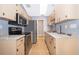 Well-lit kitchen with stainless steel appliances, granite countertops, and neutral cabinets offering a clean, modern aesthetic at 1306 Vine St, Leesburg, FL 34748