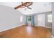 Inviting living room featuring hardwood floors, a beamed vaulted ceiling, and natural light coming from a window at 1306 Vine St, Leesburg, FL 34748