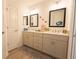 Contemporary bathroom with double sinks, modern vanities, and neutral decor at 1435 Jeremy Cir, The Villages, FL 34762