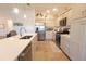 Bright kitchen featuring stainless steel appliances, light cabinetry, and quartz countertops at 1435 Jeremy Cir, The Villages, FL 34762