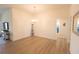 Open living room with light wood flooring, bright white walls and a chandelier, showcasing a modern and airy space at 1435 Jeremy Cir, The Villages, FL 34762