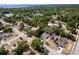 Aerial view of a residential area with tree-lined streets and well-maintained properties at 1515 Washington Ave, Eustis, FL 32726