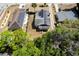 Aerial view displays a home with solar panels and a lush green backyard at 1515 Washington Ave, Eustis, FL 32726