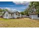 A well-kept backyard featuring a wooden fence, small deck with outdoor seating, and storage shed at 1515 Washington Ave, Eustis, FL 32726