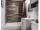 Stylish bathroom featuring wood-look tile, modern vanity, and a shower with a neutral-colored curtain at 1515 Washington Ave, Eustis, FL 32726