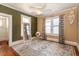 Bright bedroom with hardwood floors, a ceiling fan, and windows dressed with decorative curtains at 1515 Washington Ave, Eustis, FL 32726
