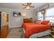 Cozy bedroom with warm colors, a wooden dresser, ceiling fan, and decor for a comfortable feel at 1515 Washington Ave, Eustis, FL 32726