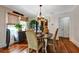Charming dining room featuring hardwood floors, a decorative light fixture, and lots of plants at 1515 Washington Ave, Eustis, FL 32726