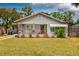 Charming single-story home featuring a front porch, gray siding, and a well-manicured lawn at 1515 Washington Ave, Eustis, FL 32726
