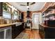 Stylish kitchen with exposed brick, wood countertops, and black cabinets at 1515 Washington Ave, Eustis, FL 32726