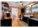 Unique kitchen with exposed brick, wood countertops, and hardwood floors at 1515 Washington Ave, Eustis, FL 32726