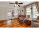Comfortable living room with hardwood floors, a red door, and views to the front porch at 1515 Washington Ave, Eustis, FL 32726