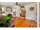 Bright living room with hardwood floors, a brick fireplace, and an open archway to the dining area at 1515 Washington Ave, Eustis, FL 32726