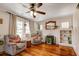 Cozy living room with hardwood floors, a brick fireplace, and built-in shelving at 1515 Washington Ave, Eustis, FL 32726