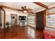 Spacious living room boasting hardwood floors, white paneled walls, and decorative lighting at 1515 Washington Ave, Eustis, FL 32726