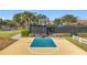 Outdoor basketball court surrounded by mature trees and landscaping for recreational use at 155 Crepe Myrtle Dr, Groveland, FL 34736