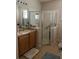 Bathroom with a glass enclosed shower, white vanity, and modern fixtures at 155 Crepe Myrtle Dr, Groveland, FL 34736