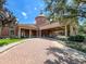 Beautiful clubhouse with a circular tower, portico, and elegant brick driveway at 155 Crepe Myrtle Dr, Groveland, FL 34736