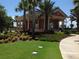 Clubhouse with manicured lawn and landscaping and sidewalk access at 155 Crepe Myrtle Dr, Groveland, FL 34736