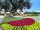 Beautiful community entrance featuring colorful flowerbeds and lush landscaping at 155 Crepe Myrtle Dr, Groveland, FL 34736