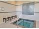 Indoor hot tub with tile surround and bench with grab bar at 155 Crepe Myrtle Dr, Groveland, FL 34736