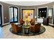 Inviting lobby with leather chairs arranged around a stylish rug and tables at 155 Crepe Myrtle Dr, Groveland, FL 34736