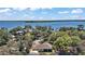 Overhead view of a picturesque property with mature trees and a beautiful waterfront setting, creating a serene environment at 15803 Fairview Pt, Tavares, FL 32778