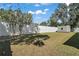 Expansive backyard with a white fence, a well-maintained lawn, and storage shed at 15803 Fairview Pt, Tavares, FL 32778