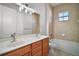 Bathroom featuring a double vanity, linen closet, and a separate tub and shower at 15803 Fairview Pt, Tavares, FL 32778