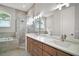 Bright bathroom featuring double sinks, shower, and soaking tub at 15803 Fairview Pt, Tavares, FL 32778