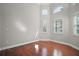 Bedroom with hardwood floors, neutral walls, natural light and architectural window details at 15803 Fairview Pt, Tavares, FL 32778