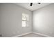 Neutral bedroom with carpet, base molding, and window with natural light at 15803 Fairview Pt, Tavares, FL 32778