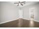 Well-lit bedroom boasts wood floors and entry to the bathroom at 15803 Fairview Pt, Tavares, FL 32778