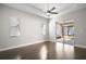 Bright bedroom with hardwood flooring, a ceiling fan, and sliding glass doors to the patio at 15803 Fairview Pt, Tavares, FL 32778