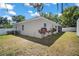 Landscaped backyard view of the house featuring a screened-in patio and a storage shed at 15803 Fairview Pt, Tavares, FL 32778