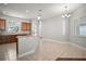 Bright kitchen and dining area with hardwood cabinets, tiled floors, pendant lights and breakfast bar at 15803 Fairview Pt, Tavares, FL 32778